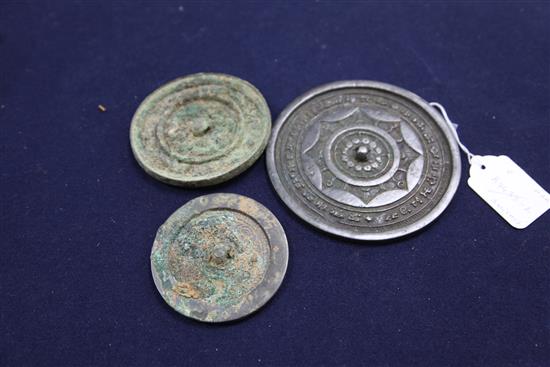 Three Chinese bronze mirrors, Tang dynasty or later, diameter 8.2cm - 13cm